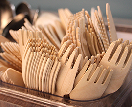 A container full of takeaway disposable wooden forks